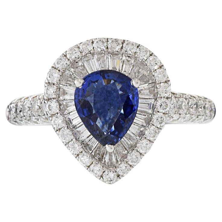 A timelessly elegant yet powerful ring crafted with 18KT white gold that features a stunning 1.24CT pear cut blue sapphire complemented by a striking 1.34CT-TW of GAL Certified G color VS1-VS2 clarity baguette and round cut diamonds. Size 6.25. Weight 6.3 gm. Blue Sapphire Diamond Ring, Pear Shaped Ring, Sapphire And Diamond Ring, Blue Sapphire Diamond, Ring Crafts, Gem Stone, Pear Cut, Round Cut Diamond, Diamond White