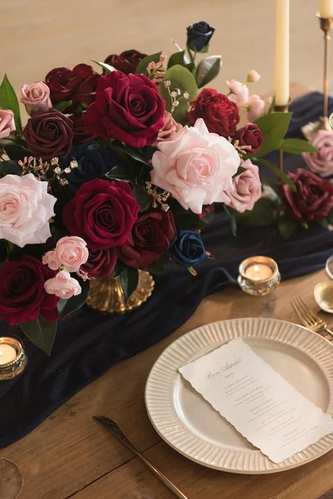 the table is set with flowers and candles