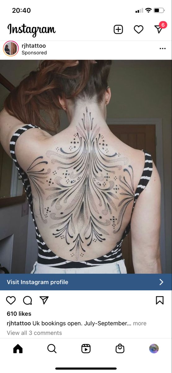 the back of a woman's body with tattoos on her upper and lower back