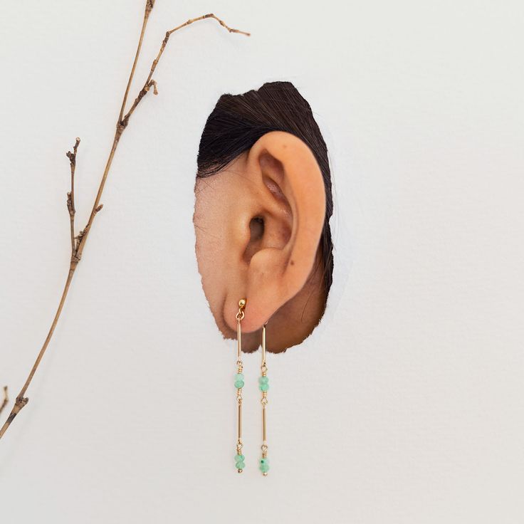 Inspired by the strength of bamboo, the Bamboo Vine Dangle Earrings feature a graceful, gold-filled design that symbolizes resilience. Handcrafted in small batches with sustainable 14k gold-filled metal, these lightweight dangle earrings, adorned with semi-precious stones like Amazonite, Iolite, Lapis Lazuli, Yellow Tourmaline, and Yellow Opal, sway gently with every movement, adding a delicate touch of femininity. Perfect for everyday wear, these hypoallergenic, artisan-made earrings offer a ti Vine Earrings, Green Bamboo, Stocking Fillers For Him, Yellow Opal, Alphabet Jewelry, Stocking Fillers For Her, Forever Jewelry, Holiday Party Outfit, Jewelry Ring Box