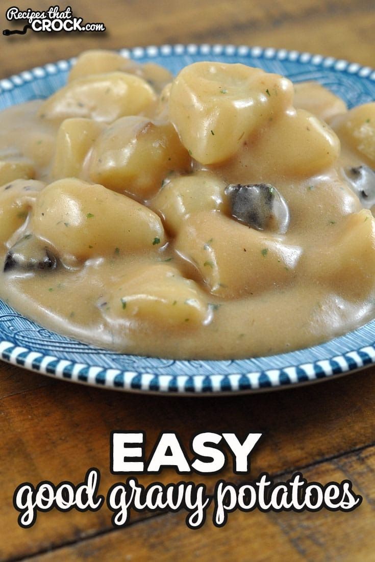 a blue and white plate topped with pasta covered in gravy on top of a wooden table