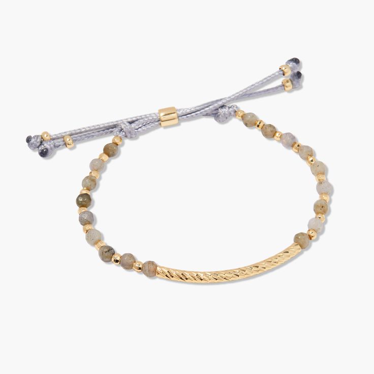 Inspire your style with the Savannah Gemstone Bracelet-Labradorite. This one-of-a-kind stunner features shining gold-plated accents and a luxurious Labradorite beads. Crafted with a toggle clasp, this exquisite bracelet will add a refined glow to your look. Available in 14k gold plated brass Size: 6" adjustable grey cord bracelet 1 1/2" hammered gold bar 4mm labradorite beads Protected with an anti-tarnish barrier SKU: BYB1211 Luxury Adjustable Labradorite Jewelry, Elegant Luxury Jewelry With Adjustable Cord, Luxury Adjustable Beaded Bracelet With Gemstones, Elegant Adjustable Labradorite Beaded Bracelets, Adjustable Gold Beaded Gemstone Bracelets, Elegant Labradorite Beaded Bracelets, Hand-strung Labradorite Gold Jewelry, Elegant Gold Labradorite Bracelets, Adjustable Beaded Labradorite Bracelets