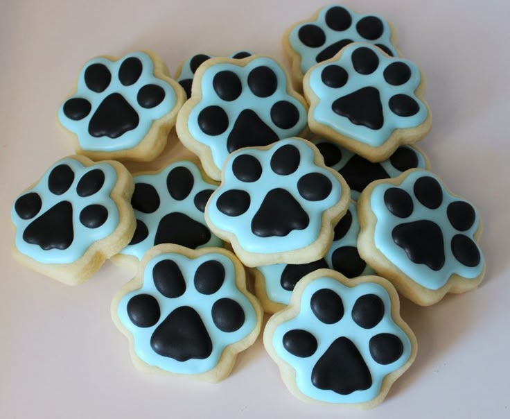 some cookies with black and blue icing are on a table