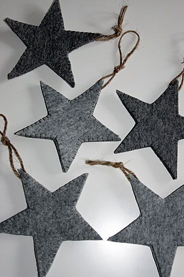 five grey and white stars hanging from twine