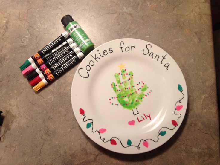 some crayons are next to a plate that says cookies for santa