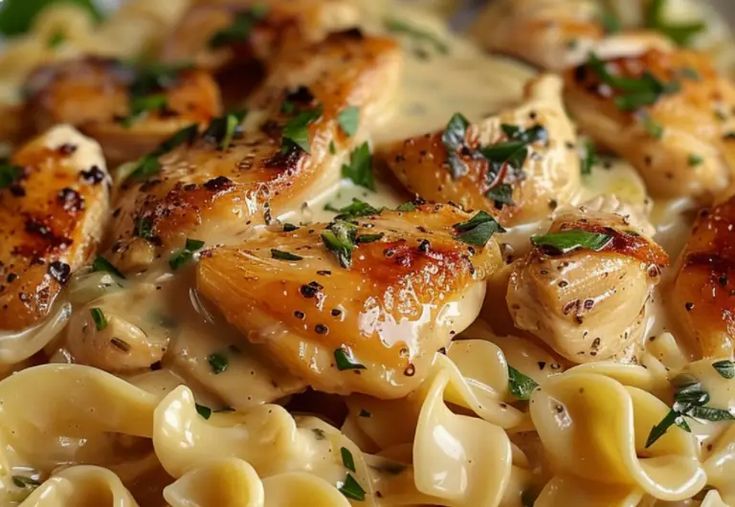 pasta with chicken and sauce in a white bowl