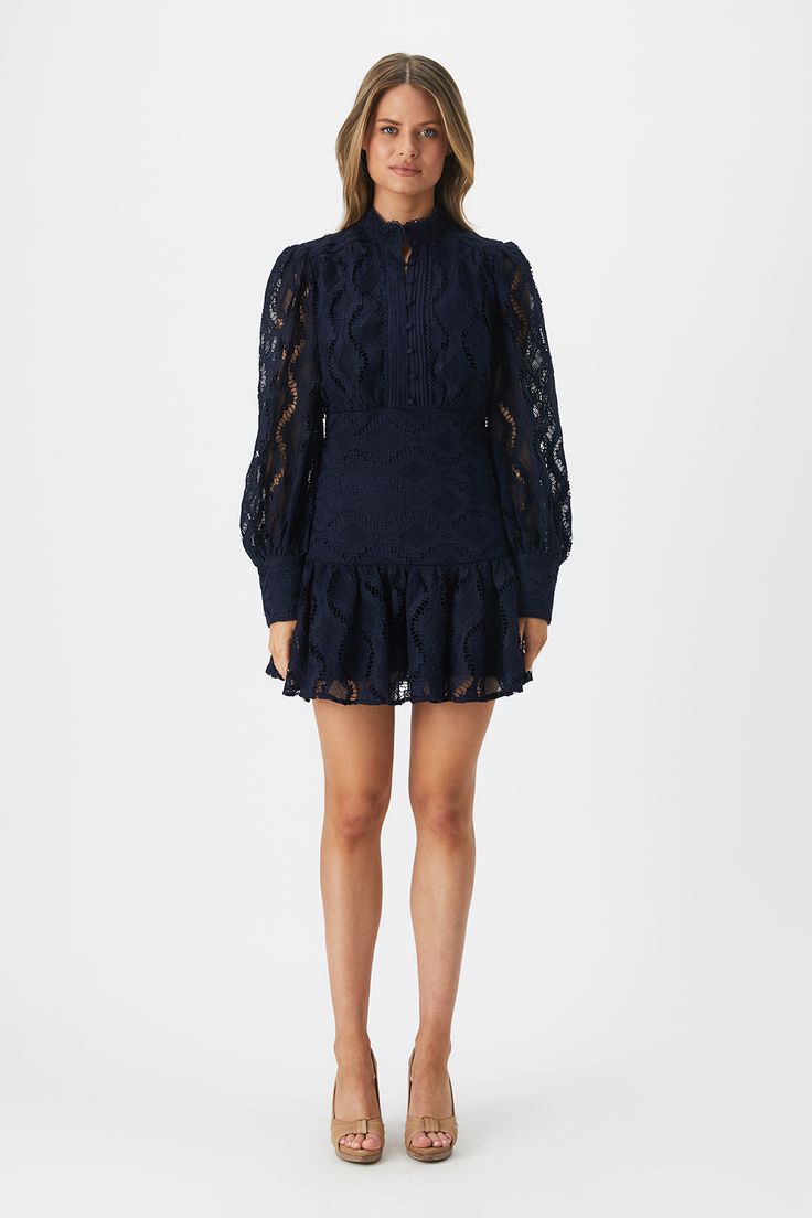 Embrace lace. The Remy Lace Dress is crafted with a free-spirited silhouette and romantic lace. The strong navy hue is striking and trans-seasonal. A wardrobe favourite.

SIZING: True to size. AU: Model wears a size 8 / US: Model wears a size 4.

FABRICATION: Main: 100% Polyester. Lining: 95% Polyester, 5% Elastane. Contrast: 100% Cotton

- Mandarin collar with fine-lace detailing
- Long balloon sleeves
- Button-down front Corsets Fashion, Day To Night Dresses, White Cocktail Dress, Essential Dress, Romantic Lace, Lace Long Sleeve, Navy Fashion, Balloon Sleeves, Mandarin Collar