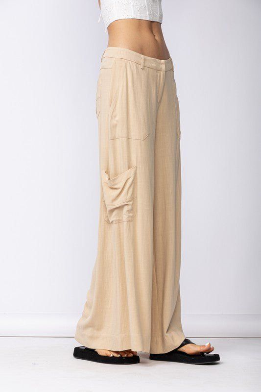 Final Sale - Get it before it's gone! Style the Cape May Beige Linen Wide-Leg Pants with your favorite summer top for a chic summer look! Linen blend fabric shapes these wide-leg pants with side cargo pockets and back patch pockets. DETAILS & CARE 70%Viscose, 30% Linen Machine Wash Cold. Imported. Spring Wide Leg Trousers With Multiple Pockets, Spring Wide Leg Parachute Pants With Side Pockets, Versatile Wide Leg Summer Cargo Pants, Versatile Summer Straight Cargo Pants, Summer Straight Leg Parachute Pants With Side Pockets, Summer Wide Leg Parachute Pants With Pockets, Summer Wide-leg Cargo Pants With Side Pockets, Summer Wide Leg Cargo Pants, Summer Ankle-length Bottoms With Patch Pockets