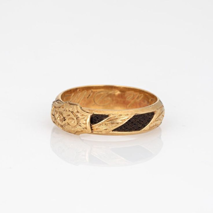 Finely detailed antique Victorian ring (circa 1880s to 1900s), crafted in 18 karat yellow gold.    In the Victorian era, hair jewelry held immense sentimental value and served as a unique and poignant form of remembrance and mourning. The ring has intricately braided hair embedded into the band and around the entire circumference of the ring. Hair jewelry was a deeply personal and intimate memento symbolizing the eternal connection between the living and the departed. Hair jewelry today if sought after by collectors for their tangible links to a bygone era of remembrance and expression. The band has a low profile, rising 3mm from the finger (0.11 inches) and sits comfortably on the finger. The ring is a larger size (US 10) and is unfortunately not sizable. The inner band is engraved 'Amali Antique Engraved Ring With Decorative Band, Victorian Enamel Ring For Anniversary, Victorian Enamel Ring Engraved For Anniversary, Victorian Engraved Ring With Decorative Band For Anniversary, 22k Gold Victorian Ceremonial Jewelry, Ceremonial Brass Rings With Engraving, Ceremonial Engraved Brass Rings, Victorian Engraved Enamel Ring For Anniversary, Ceremonial Gold Engraved Ring