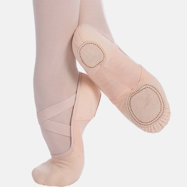 the legs and feet of a ballerina in pink ballet shoes, with their soles showing