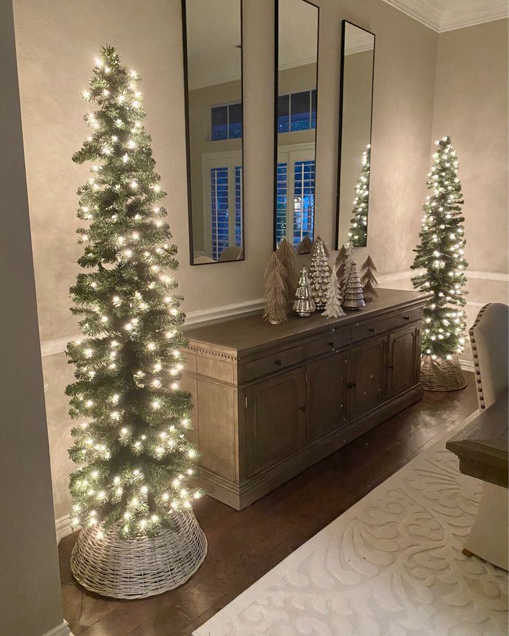 a christmas tree is lit up in front of two mirrors