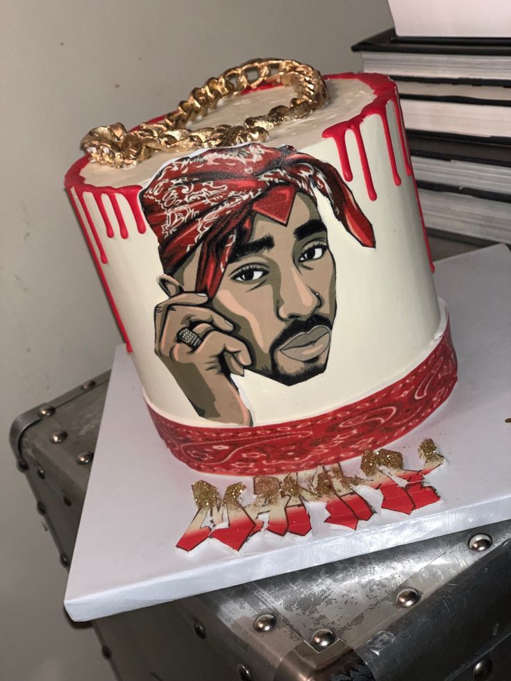 a cake with a painting of a man wearing a bandana and holding a cell phone to his ear