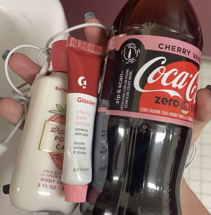 a person holding three different types of toothpaste and mouthwash in their hands