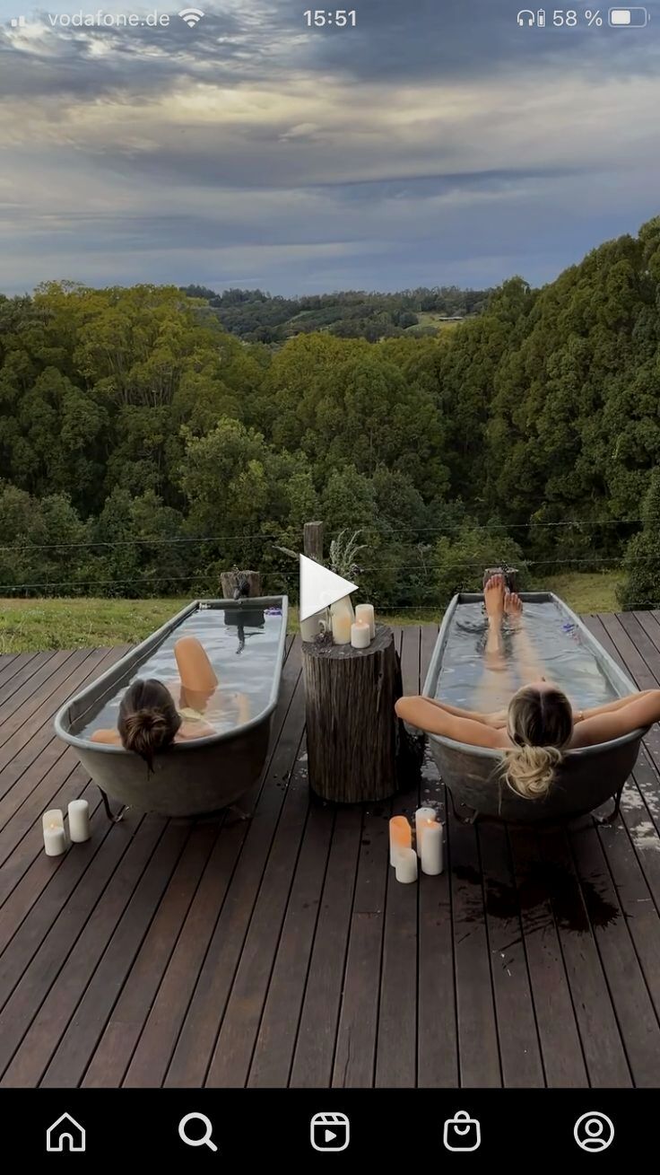 two people are sitting in an outdoor hot tub