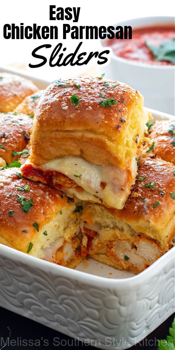 chicken parmesan sliders stacked on top of each other in a white casserole dish