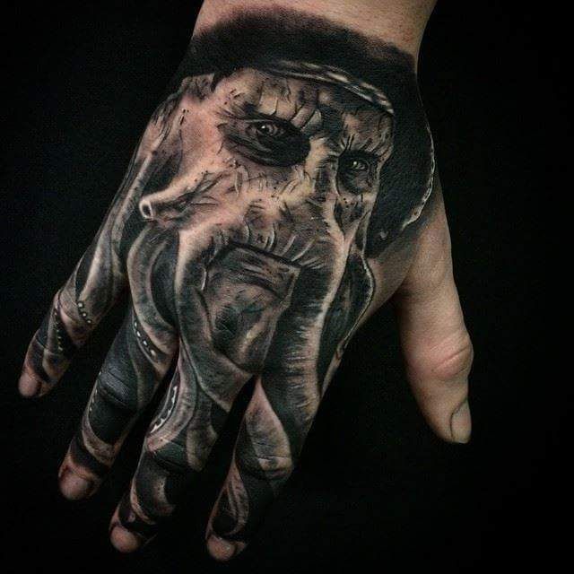 a hand with an elephant tattoo on it