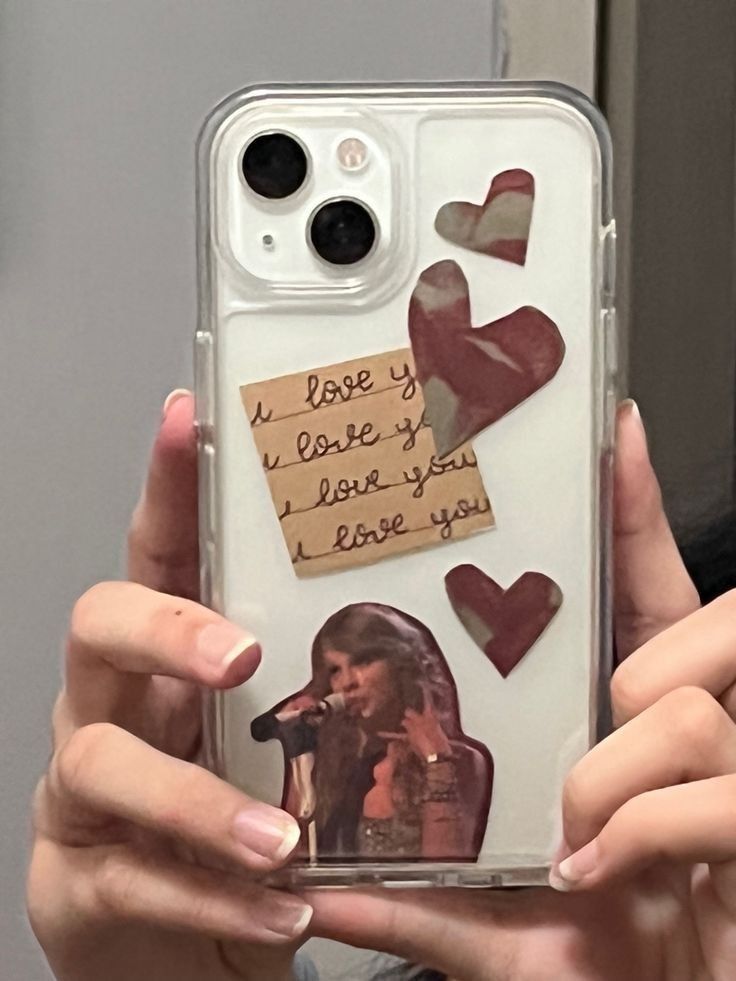 a person holding up a phone case with hearts and notes on the back that says i love you