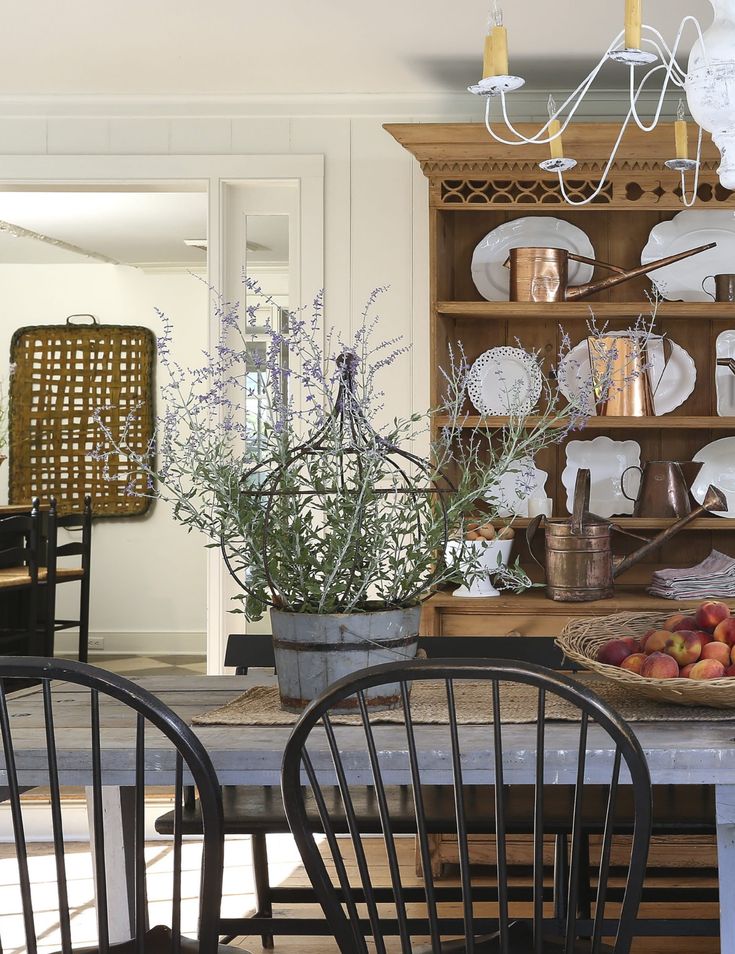 a dining room table with chairs and plates on it