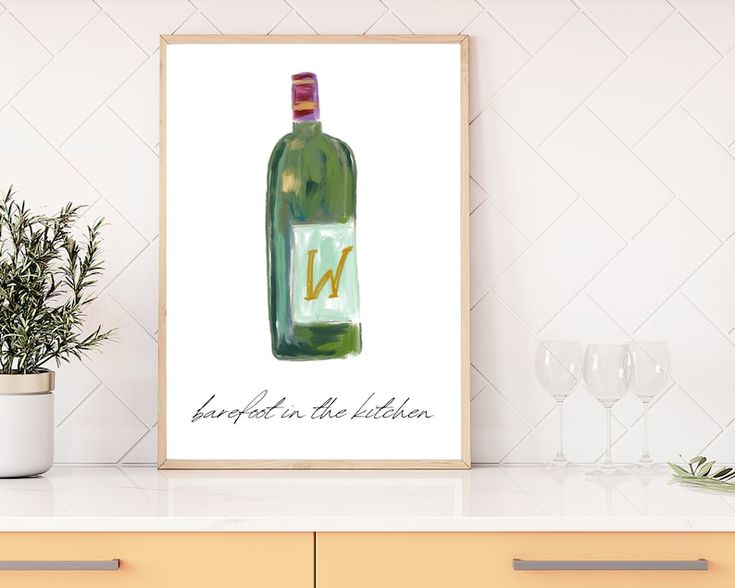 a wine bottle with the letter n on it is displayed next to some glasses and a potted plant