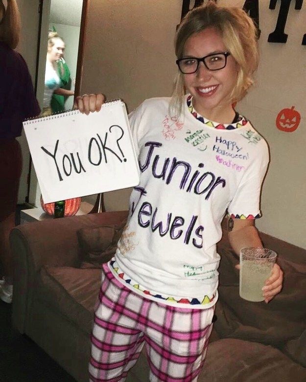 a woman in pajamas holding up a sign