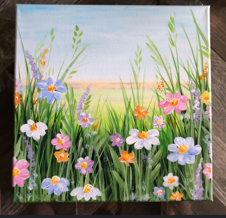 an acrylic painting of flowers and grass on a wooden surface with the sky in the background