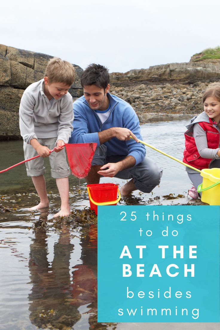 two adults and one child are playing in the water