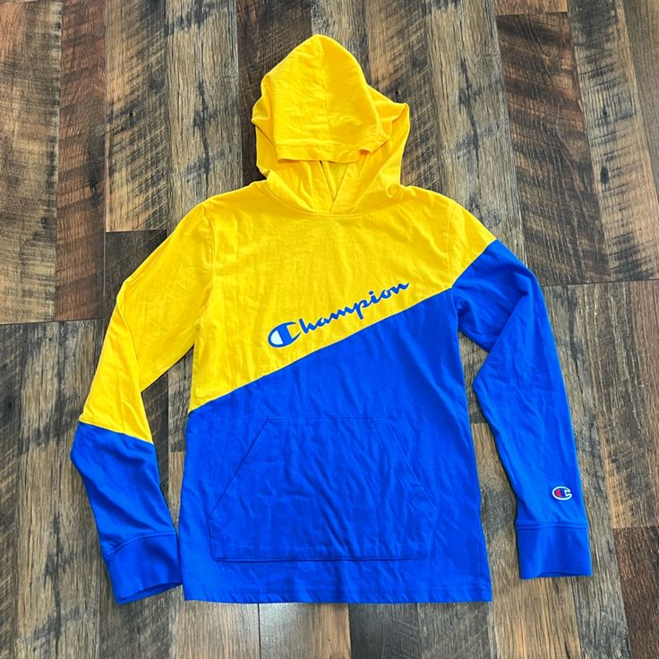 Two-Tone Long Sleeved Shirt By Champion Hood Large Front Pocket Blue And Yellow Length: 21.5” Width: 14.5” New Without Tags; No Flaws Yellow Color Block Cotton Sweatshirt, Yellow Long Sleeve Sports Sweatshirt, Hooded Color Block Cotton Top, Yellow Cotton Color Block Sweatshirt, Blue Color Block Crew Neck Hoodie, Yellow Color Block Hoodie For Winter, Yellow Cotton Long Sleeve Hoodie, Blue Color Block Hooded Top, Yellow Cotton Crew Neck Hoodie