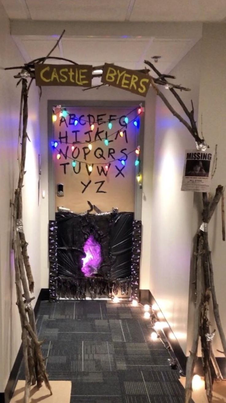 the entrance to castle byes is decorated with lights and branches for halloween decorating