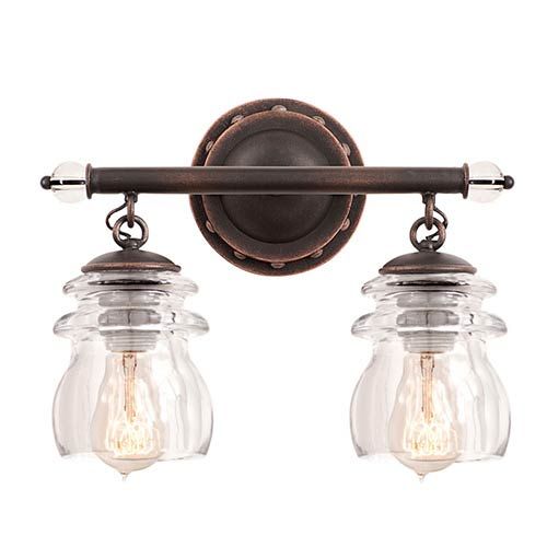 two light bathroom fixture with clear glass jars on the bottom and an antique bronze finish