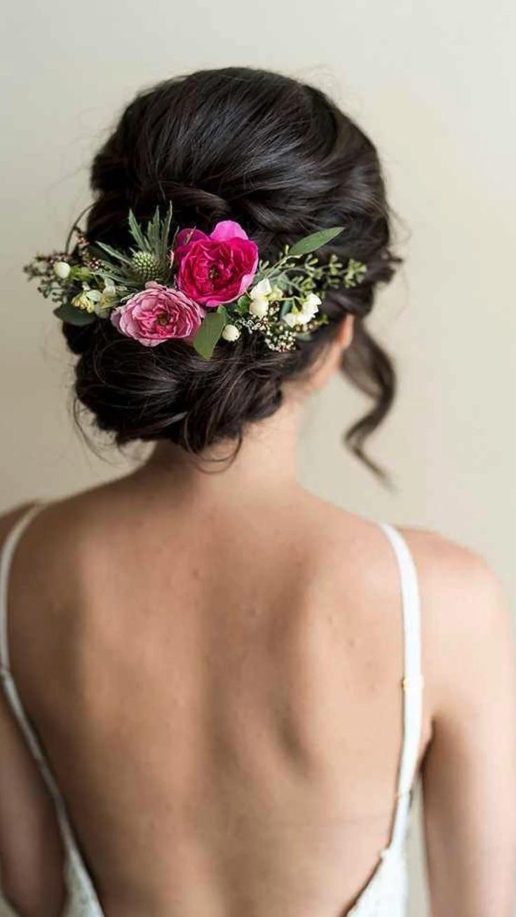 a woman with flowers in her hair wearing a white tank top and floral headpiece