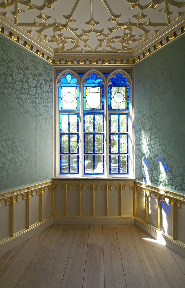 an empty room with wooden floors and blue glass windows