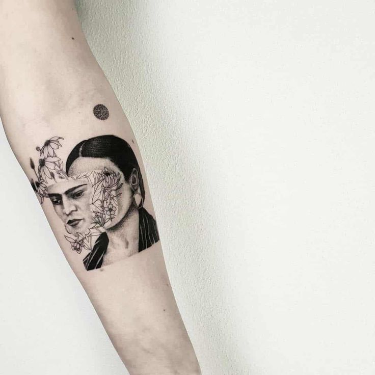 a woman's arm with a tattoo on it and an image of a man