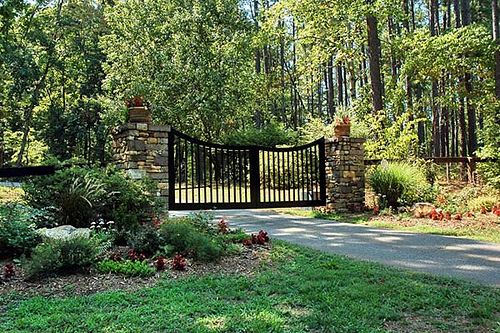 a gated entrance to a lush green park