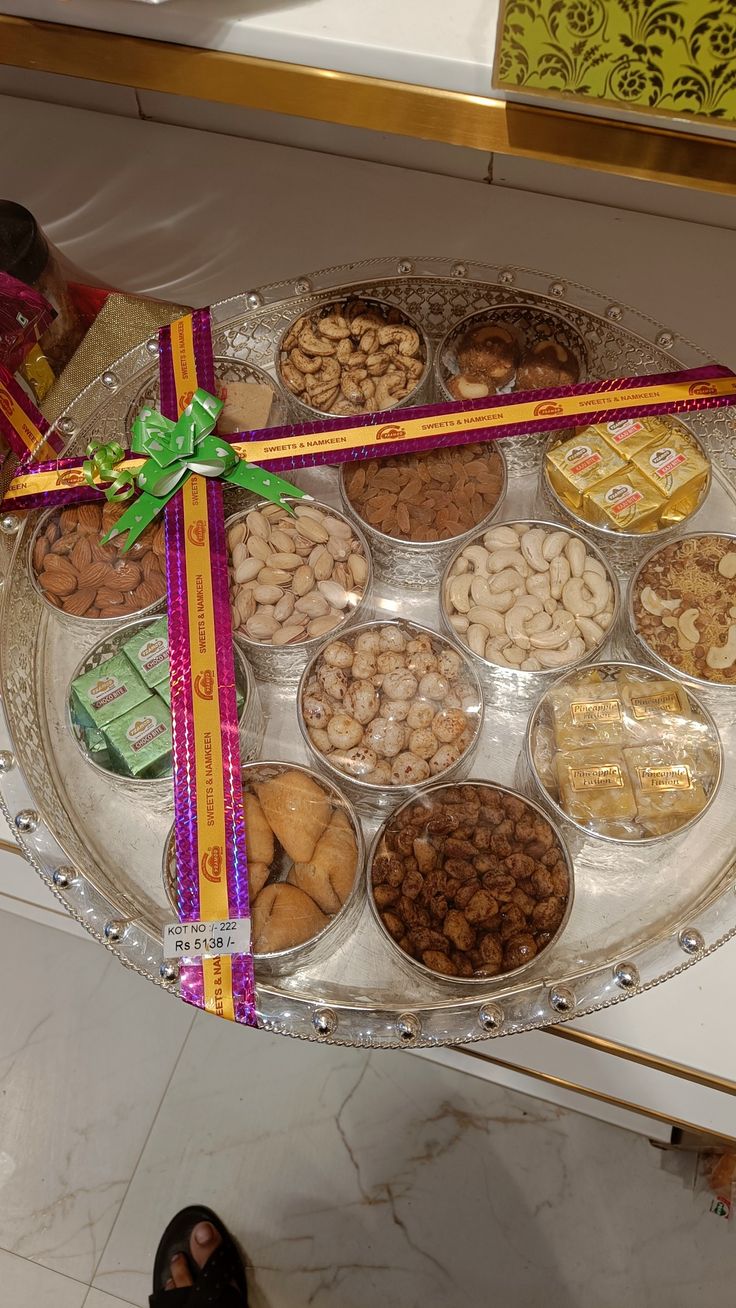 a tray filled with lots of different types of food on top of a white table