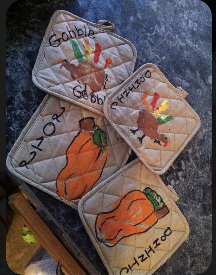 three oven mitts decorated with thanksgiving decorations