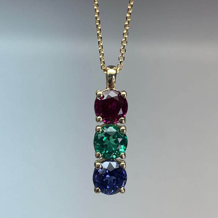 "The pendant pictured is lab created sapphire #7119 This necklace can be made with any color birthstone Please Contact us before you purchase to make sure we have the desired birthstones available. Changing stone colors may change the price of the necklace Please message us before purchasing if you would like to change stone colors. -Approximate total carat weight: approx. 1.50ctw diamond equivalent -Center Stone Size: 5mm - approx. .50ct each diamond equivalent -Center Stone Shape: 3 round -Gem Multi Stone Jewellery, Two Stone Pendant Design, Stone Pendants Gold, 3 Stone Pendant, 18kt Gold Jewelry, Gem Stone Pendant, Gem Stone Necklace, Gold Birthstone Necklace, Diamond Pendant Jewelry