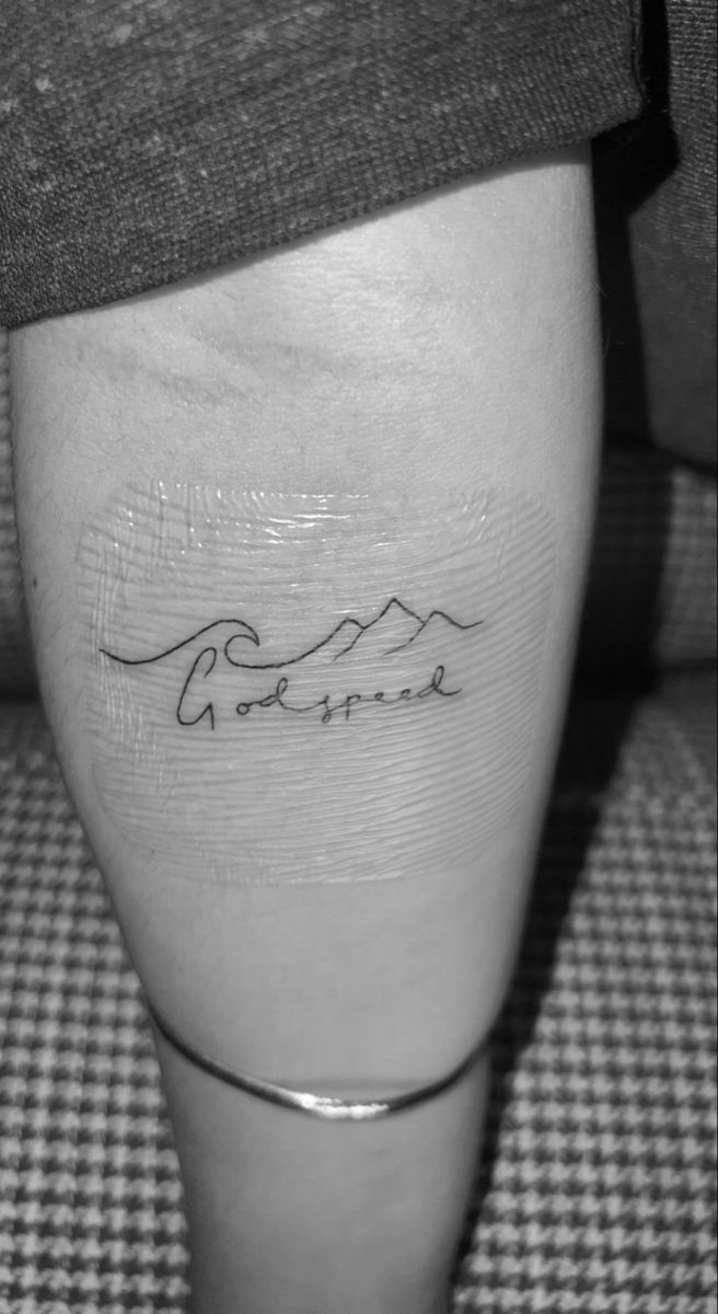 a person with a tattoo on their leg that says, love is never in the mountains