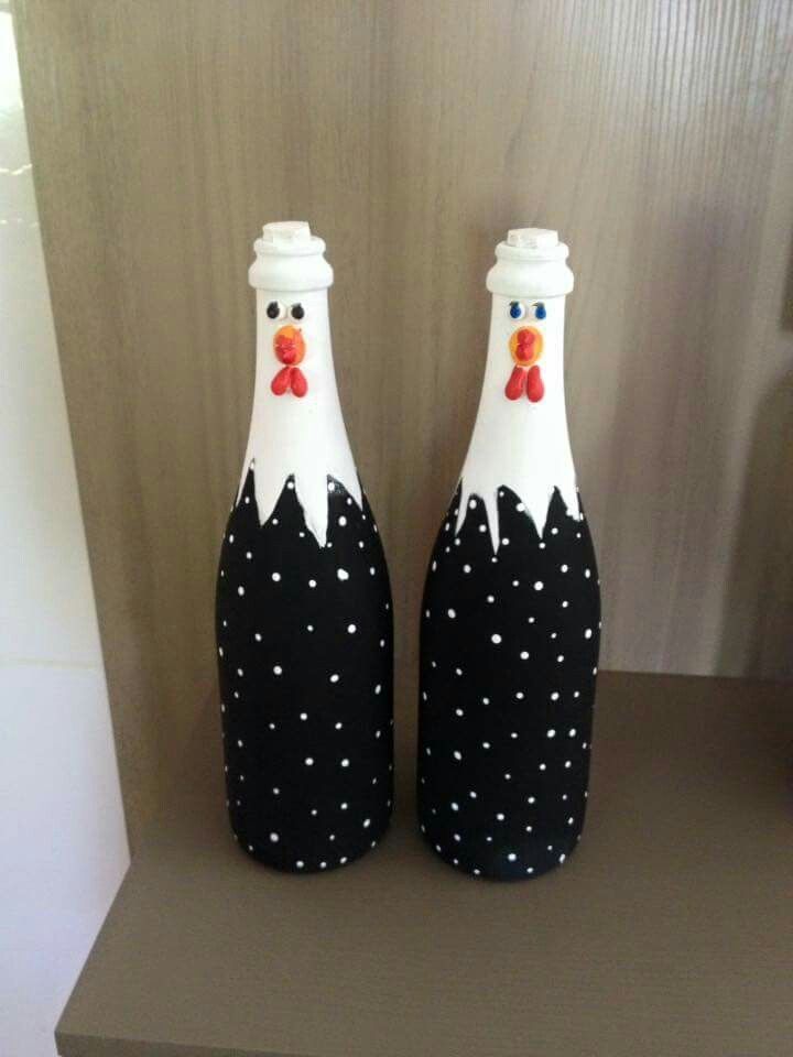 two decorated wine bottles sitting on top of a table