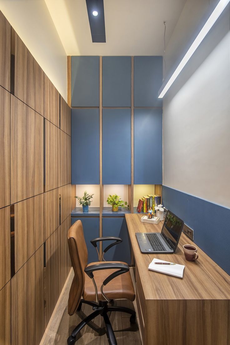 a desk with a laptop on it in an office