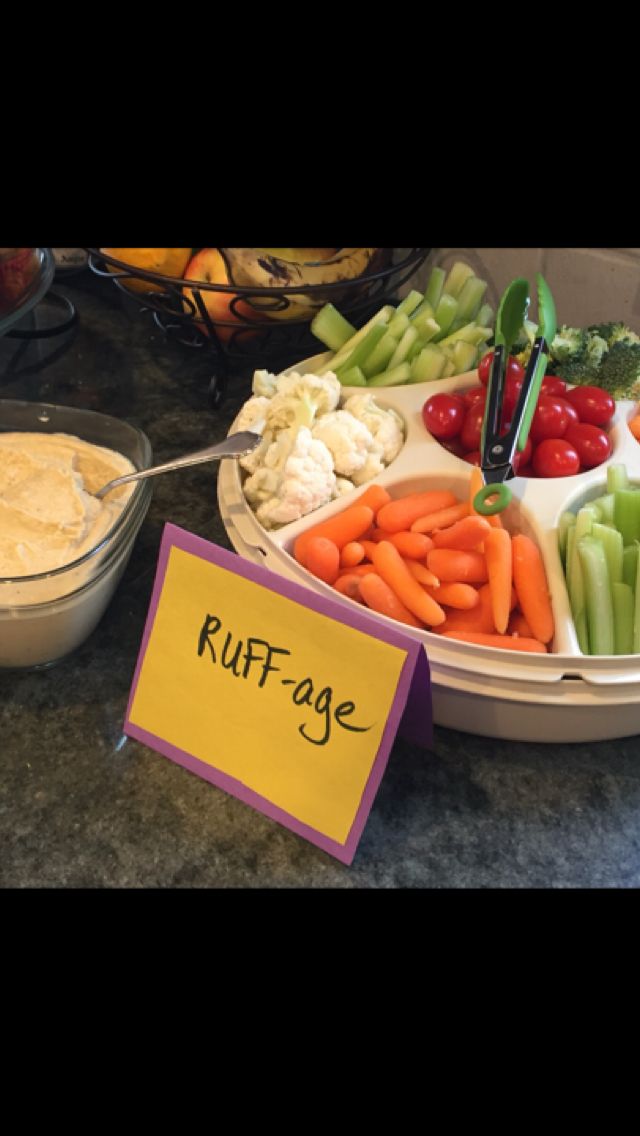 a variety of fruits and vegetables are displayed on a table with a sign that says ruff - age