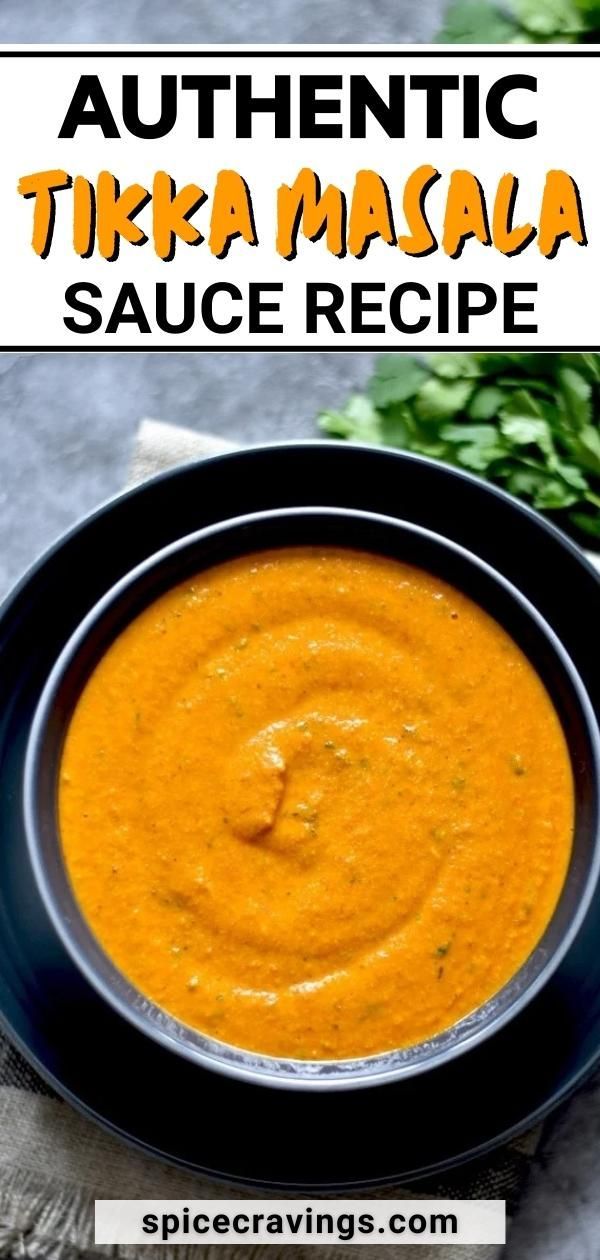 a black bowl filled with sauce on top of a table