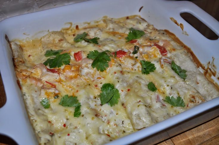 a casserole dish with chicken, cheese and cilantro garnish