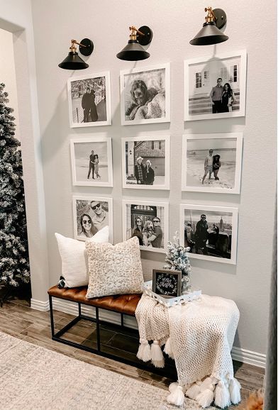 a living room decorated for christmas with pictures on the wall