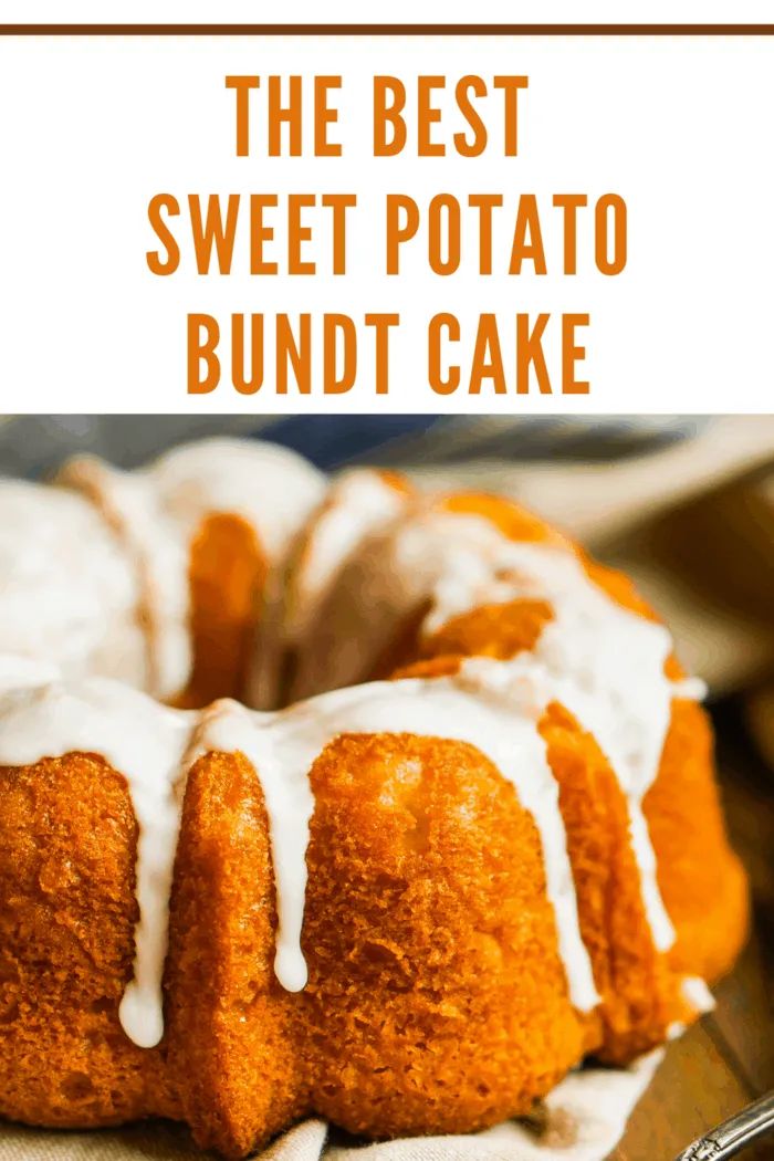 a bundt cake with white icing sitting on top of a table