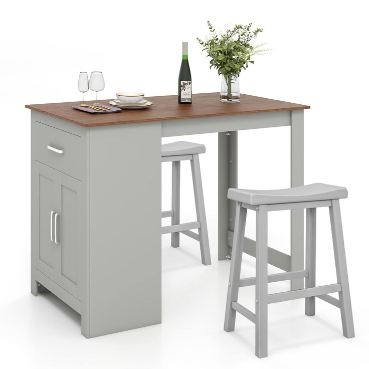 a kitchen table with two stools next to it and a bottle of wine on the counter