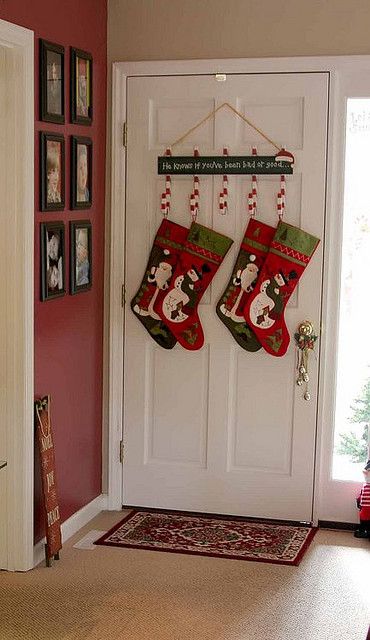 two christmas stockings hanging on the front door