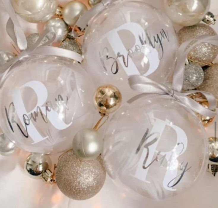 christmas ornaments with the word happy new year written on one ornament in white, gold and silver