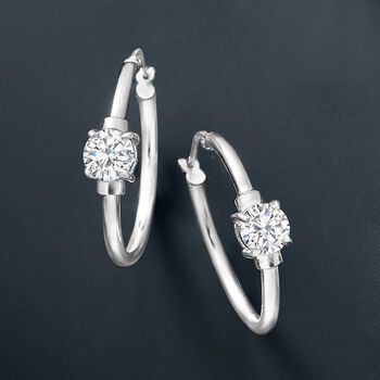 Ross-Simons - 1.60 ct. t. w. Cubic Zirconia Station Hoop Earrings in Sterling Silver. 1". CZ the moment. Sleek sterling silver hoop earrings sparkle with 1.60 ct. t. w. CZ stations. Hanging length is 1". Snap-bar, CZ hoop earrings. CZ weights are diamond equivalents. Classic Silver Hoop Earrings With Brilliant Cut, Classic Silver Small Hoop Diamond Earrings, Sterling Silver Hoop Earrings For Anniversary, Classic Silver Earrings With Channel Set, Classic Silver Hoop Earrings With Prong Setting, Classic Silver Hoop Diamond Earrings, Anniversary Sterling Silver Hoop Earrings Channel Set, Sterling Silver Channel Set Hoop Earrings For Anniversary, Classic Sterling Silver Hoop Earrings Channel Set