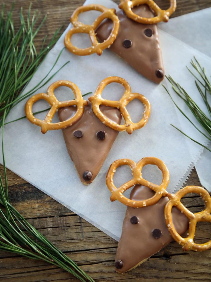 chocolate and pretzels are arranged on top of paper