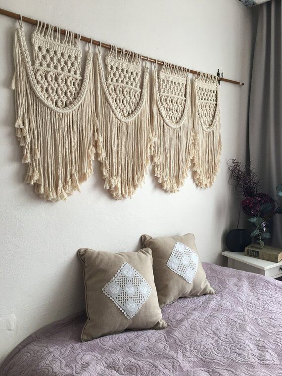 the wall hangings are decorated with crochet and tassels